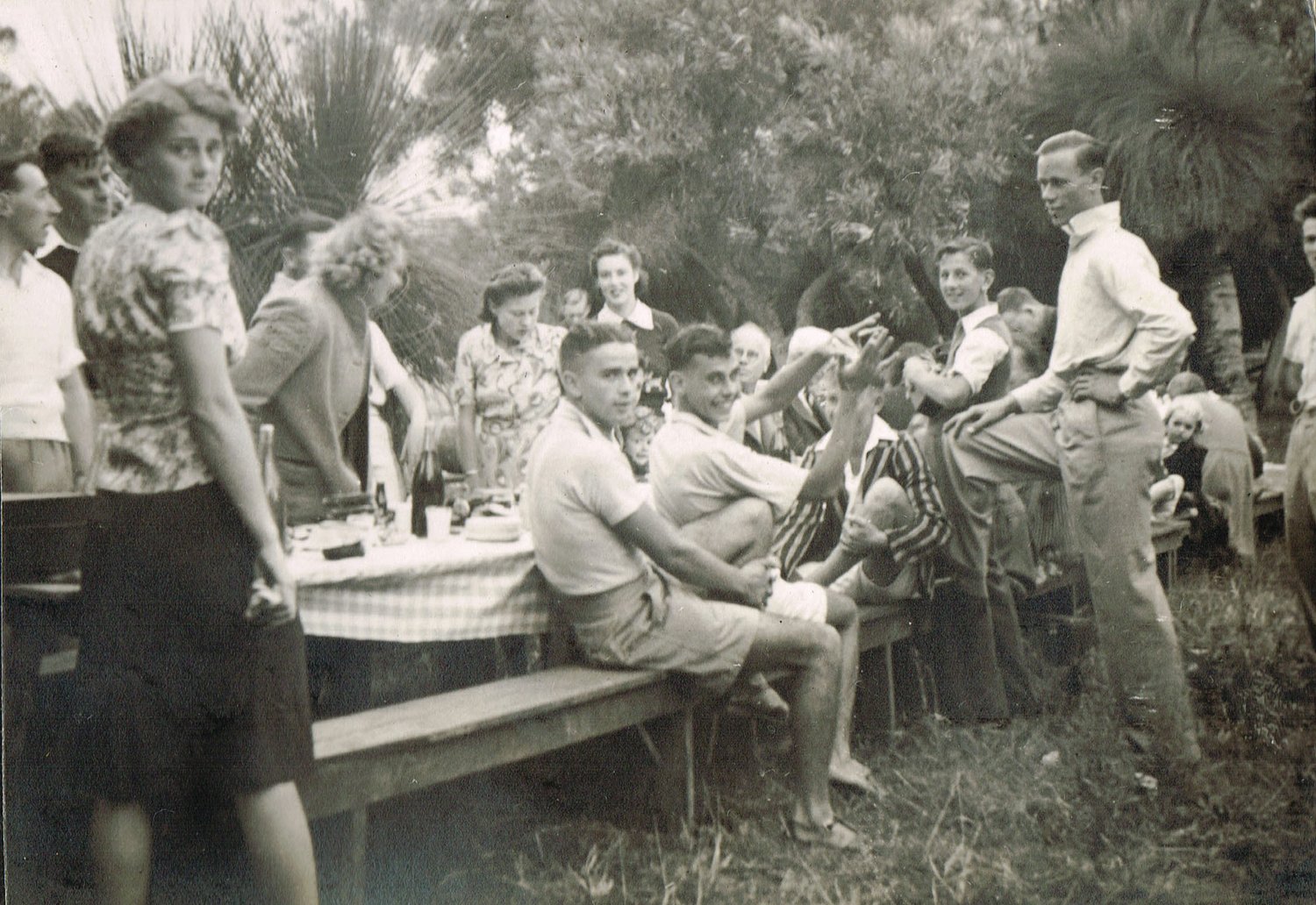 A J Baker & Sons’ staff picnic at Yanchep, 1941. Bert Baker is seated center background. Geoff Baker in trousers with foot up on the bench.