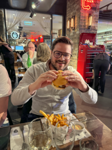 Riccardo from Criocabin enjoying a burger in an Italian Restaurant.